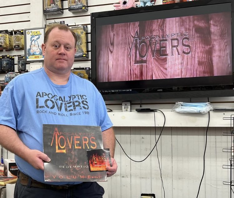 apoclovers's tweet photo. @TheOneTrueJay of @KNAC sporting his new @apoclovers T + physical copies of our album! Whether ur writing or listening to new music it takes you on a journey like nothing else! We are so glad Jay that you are with us and can not THANK YOU enough for the reviews and purchases!🤟❤️ https://t.co/ARe5hq8cCb
