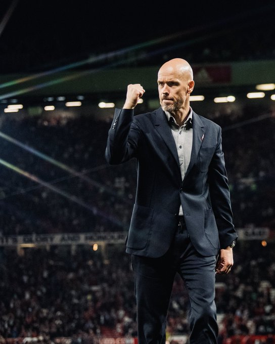 Erik ten Hag shows his fist in celebration to the United crowd at the full-time whistle.