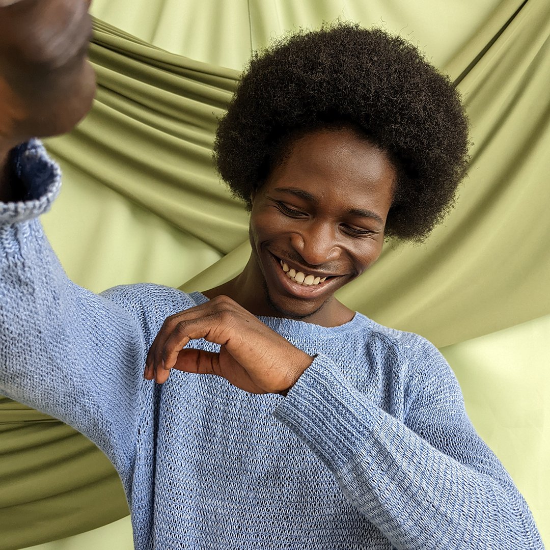 Man smiles as he poses for a photo.