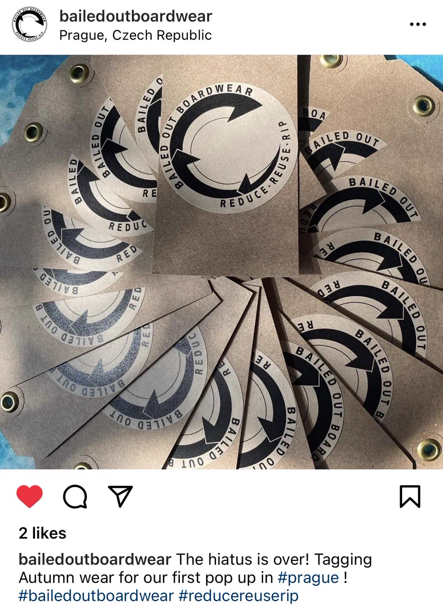 An Instagram Post, showing clothing tags being prepped for the surfware brand “Bailed Out Boardwear”. The caption says “The hiatus is over! Tagging Autumn wear for our first pop up in #prague !”
