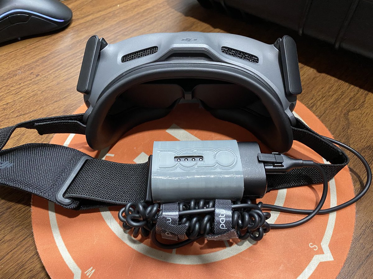 DailyDroning's tweet photo. It’s such a simple upgrade for the Goggles, but not having that cable and battery dangling is a huge upgrade for me. Can’t believe @DJIGlobal don’t build something like this into their kit. https://t.co/pnEtqrUjju