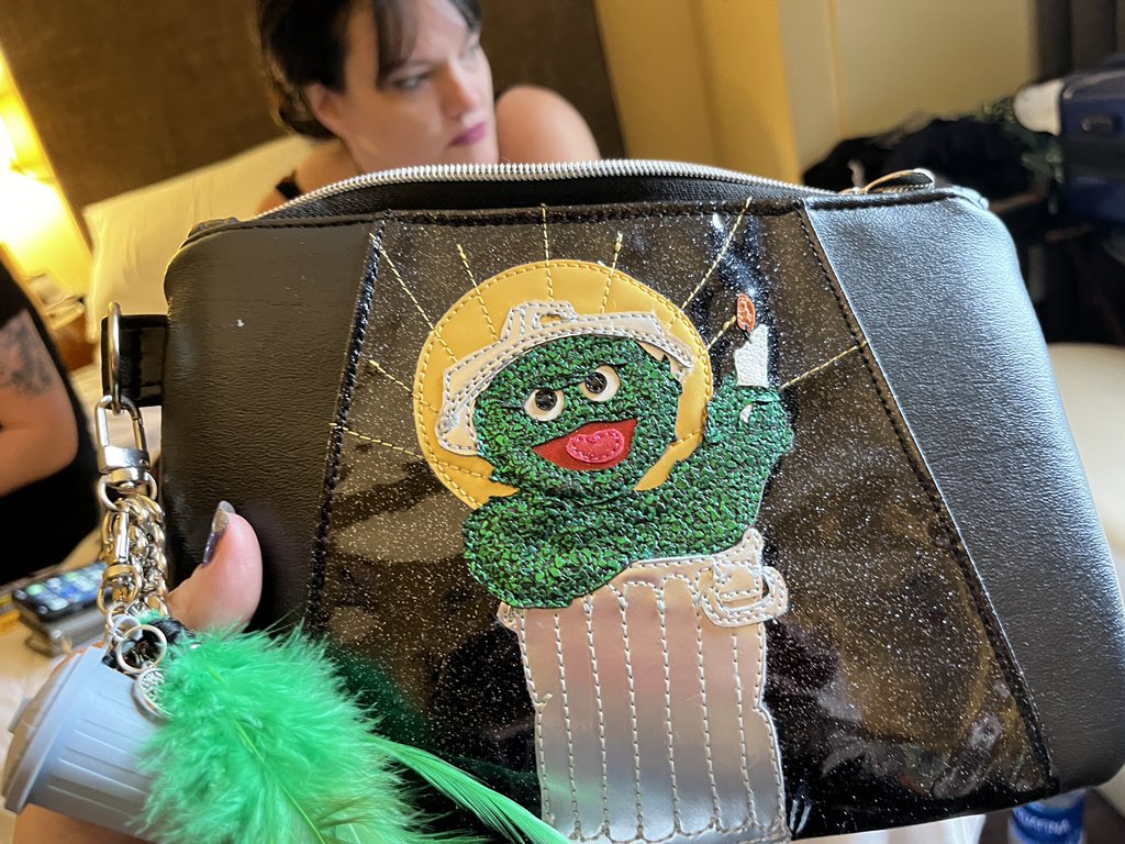 Pistachio's tweet photo. Oscar, patron saint of #ThePastisRed, in custom clutch form for the #HugoAwards by @AliciLee of #CutpurseCreations #worldcon2022 #Chicon8 https://t.co/Iytfq8kGqk