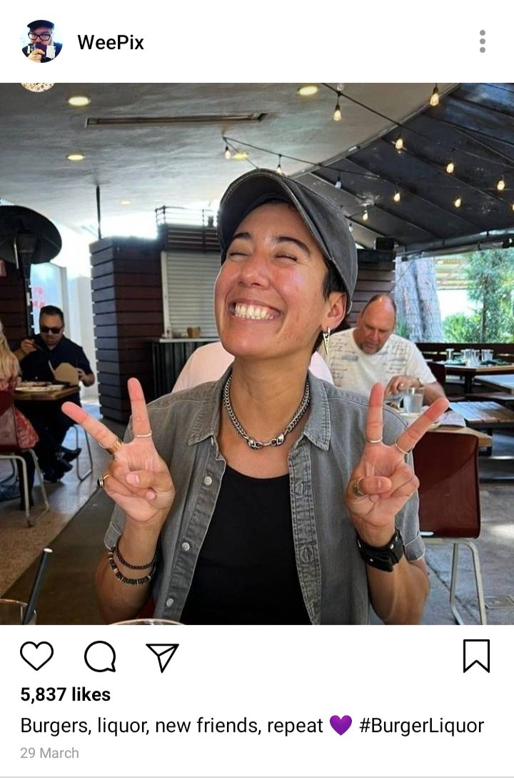 John's IG. Picture of Jim smiling for camera. Cpation: Burgers, liquor, new friends, repeat. 