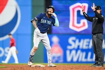 J.P. Crawford celebrates at second base after driving in the go-ahead run.