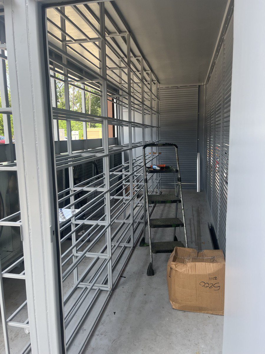 4energytech's tweet photo. Setting up rack for (216) S19 / (240) M30s in a 20ft BitTank. The structure is ready. The fans are evenly distributed across a long wall of a high cube box assuring a uniform heat removal✊ Working on the filtering wall and ⚡️power panel. @aiproenergy #bittank #bitcoinmining https://t.co/BCASzFy9Eb