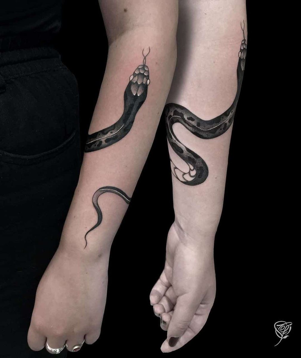 Matching snake and sword tattoo for couple.