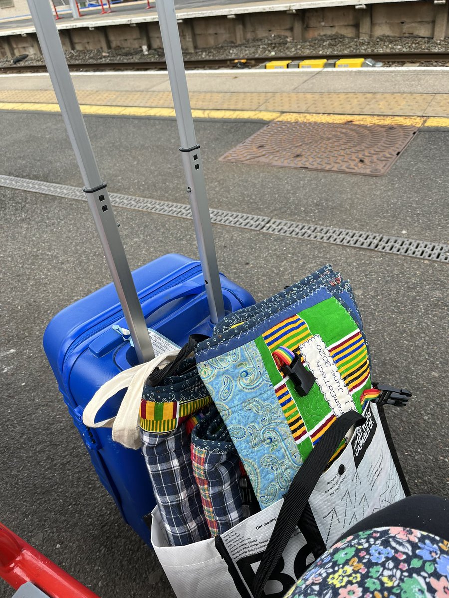 francesbell's tweet photo. Bag lady with quilts prepares to get on train to Manchester for #altc22 #femedtechquilt #femedtech https://t.co/eg4actst66