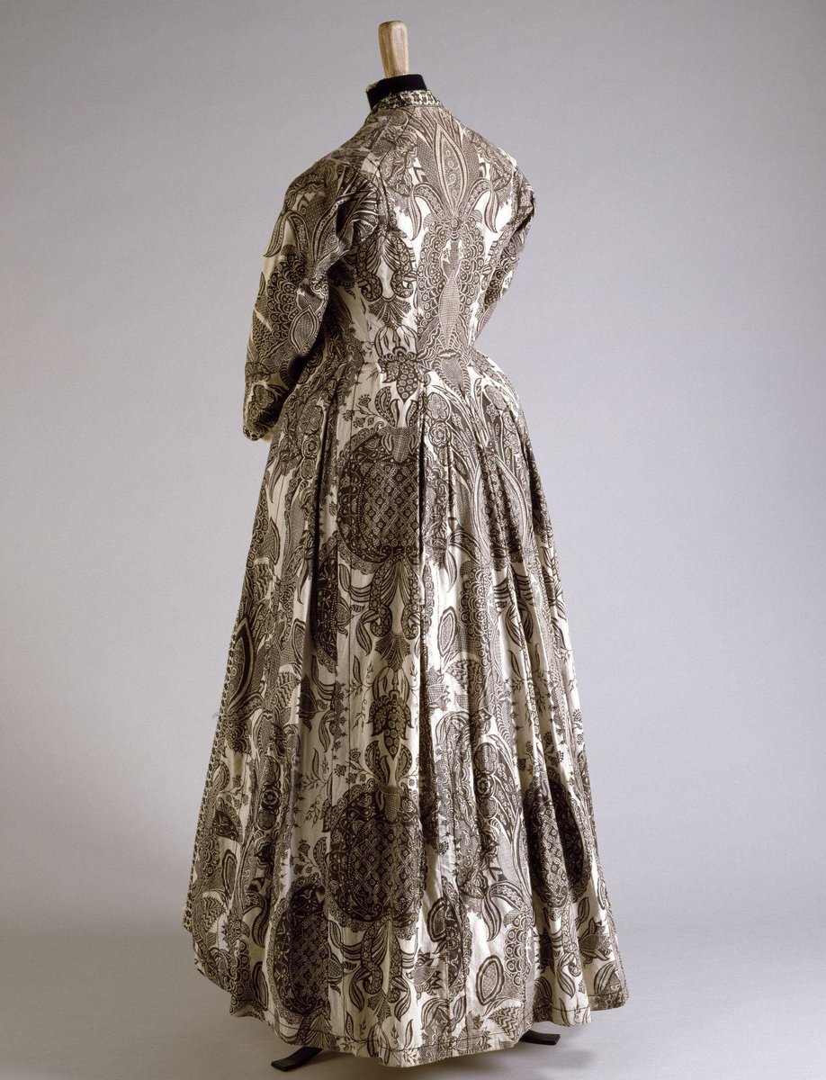 This 18th century chintz dress would ordinarily have been made in colourful fabric. 

This monochrome exception was probably intended as mourning wear.
