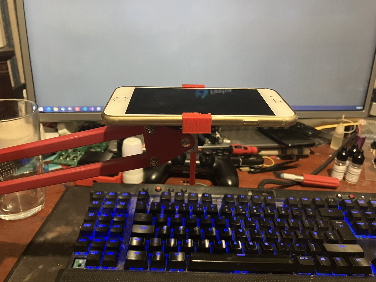 CrosseyeJack's tweet photo. I needed a desk cam for a short period. Tried mounting my webcam in weird spots including trying to sit it on my mic arm. Then it dawned on me. JACK YOU HAVE A 3D PRINTER YOU IDIOT! So made a mount for my mic arm to hold my old phone and boom problem  solved. https://t.co/OTfZapz6QE