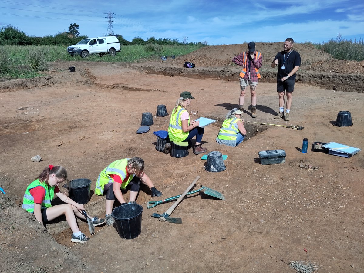 ExploreThePast's tweet photo. #RootsInTime dig diary day 7: Work got underway on ditches in Tr10 - few finds sadly, but does suggest they're livestock pens or fields.

In Tr6 a small pit is appearing under the midden material, and most of the ditch slots in Tr3 are now excavated ready for recording tomorrow. https://t.co/QRY1BGfx46