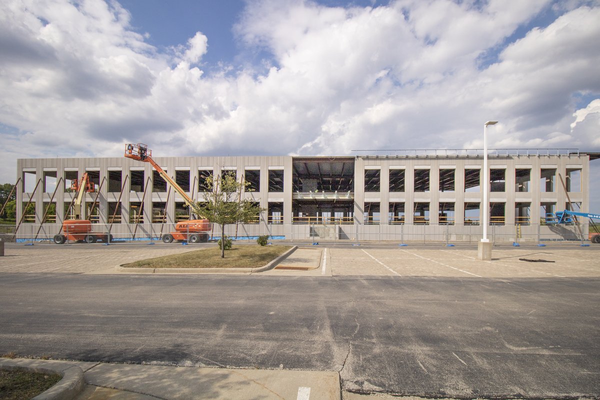 #InnovationOne update! The precast parking structure is starting to go up. Pieces of precast are being set using a massive 350-ton crane. Steel crews are finishing up detailing and the slab on the grade floor is being poured on the garden level.