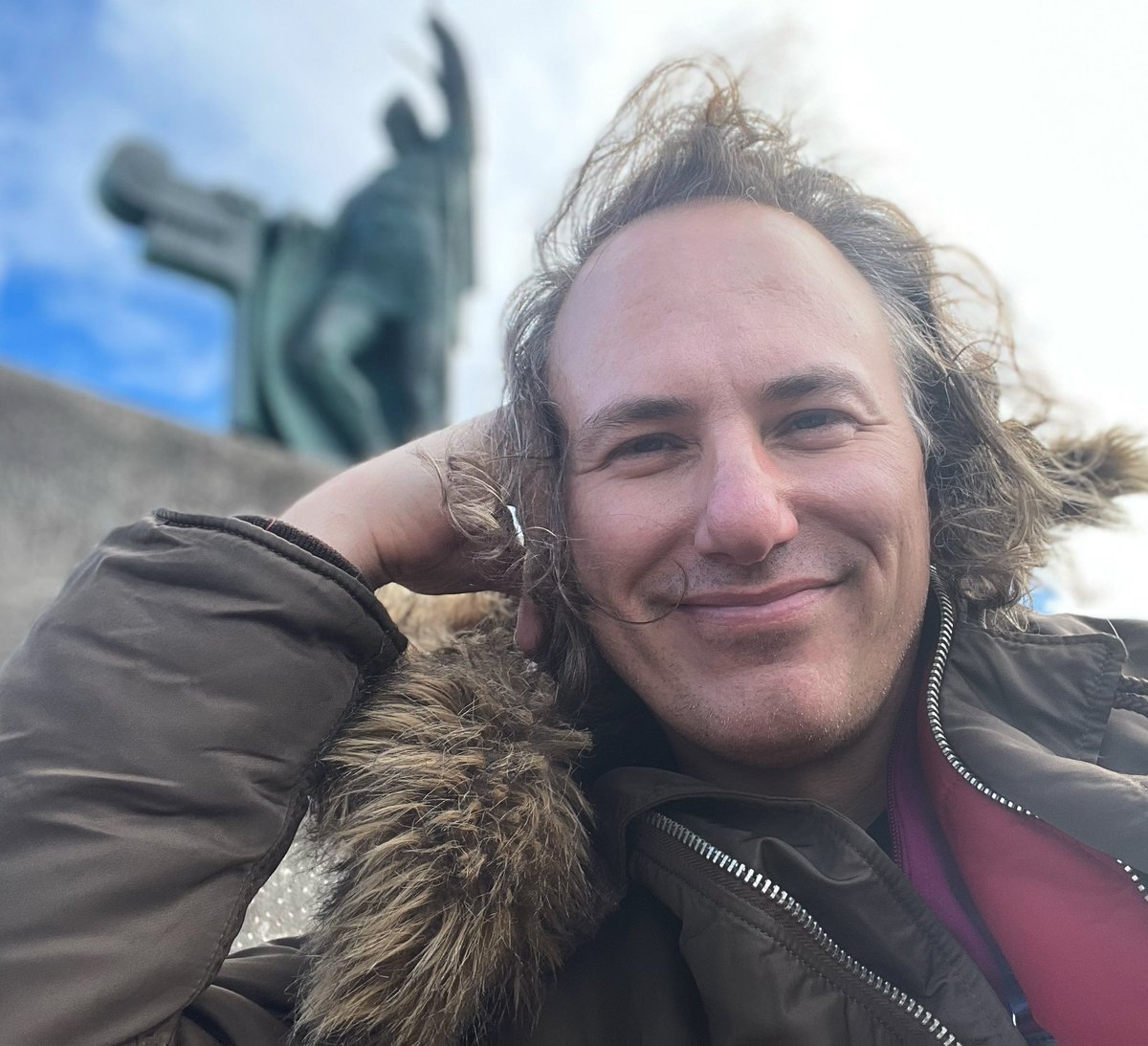 JoshuaHarrell's tweet photo. I made it to Reykjavik. I’m on a hill overlooking where the new part of the town meets the older part—taking it all in. #WorldViaMe https://t.co/YxrRaGA49c