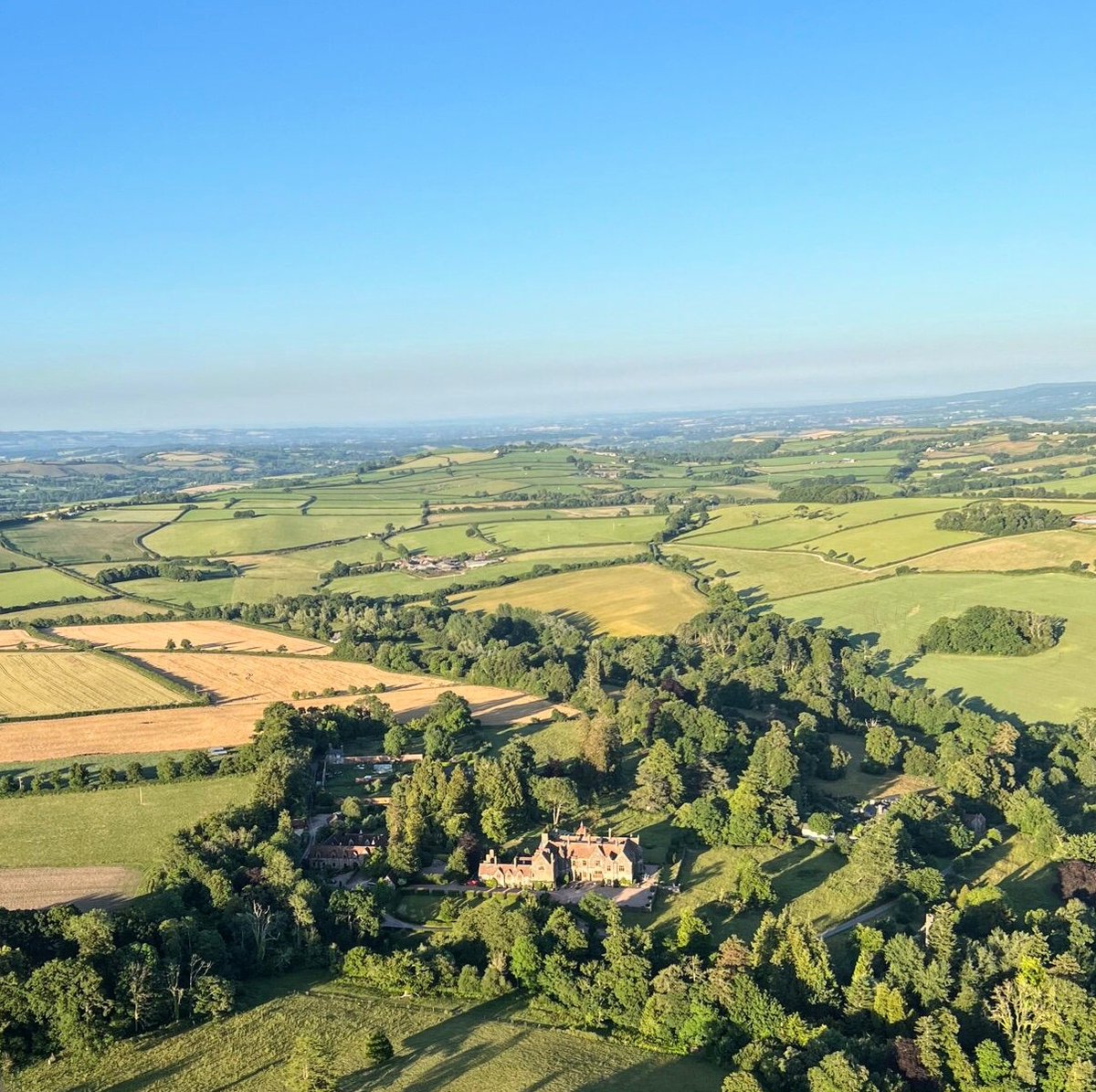 Huntsham Court from above! As you can see, we are surrounded by beautiful Devon #countryside... Which is why we are often described as a #hiddengem wedding venue. Now taking bookings for 2024, #enquire for more details! #wedding #gettingmarried #ido #weddingvenue #venue #Devon