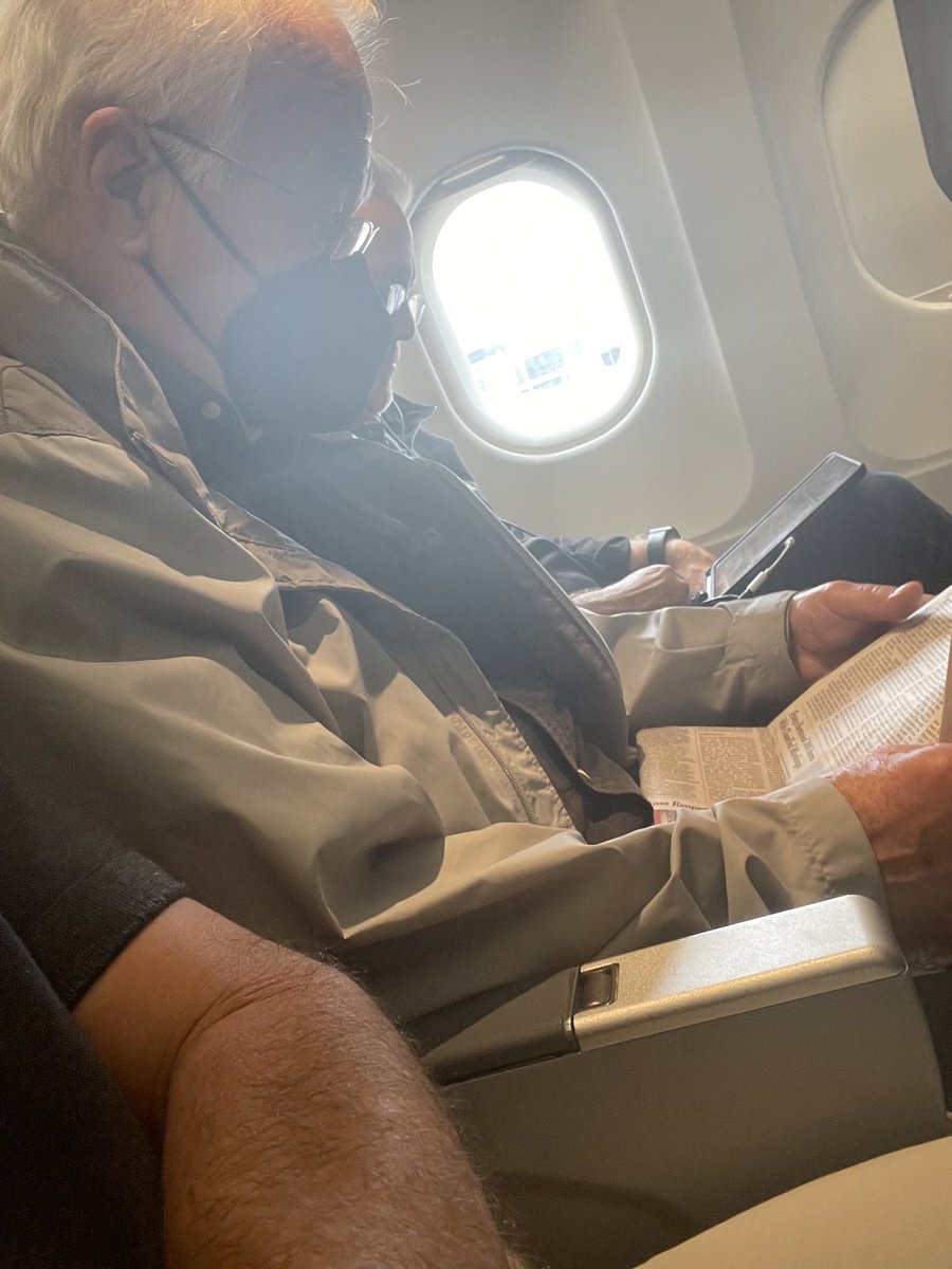 Man next to me on the plane appears to have brought some sort of paper with pictures and words on it. I wonder if this type of ‘news’ paper will catch on