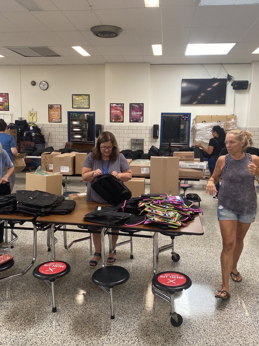 Hackensack Middle School Staff hard at work packing school supplies and book bags for OUR HMS Comets! 💙💛 #oneteamonefamily