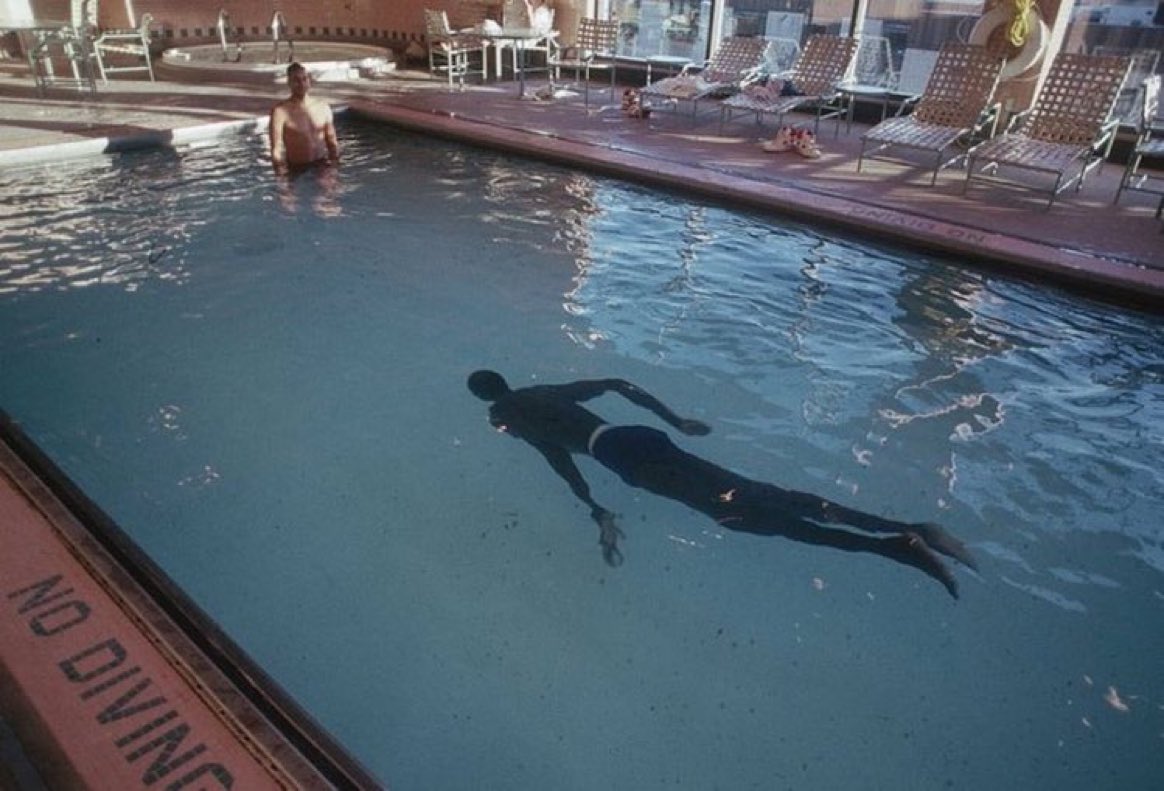 Super70sSports's tweet photo. Manute Bol swimming looks almost exactly like you'd imagine it would. https://t.co/bhhikRtv7I