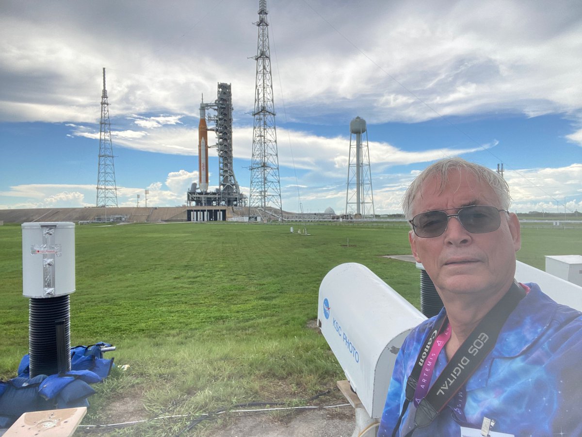 ken_kremer's tweet photo. So happy!! We just finished remote cam setup inside #pad39b - after 3 h rain/lightning delay @NASAKennedy . For upcoming #Artemis1 launch Aug 29 at 833 am ET. Posing with #SLS mega moon rocket - most powerful nasa rocket ever! https://t.co/2VbomAWVfQ