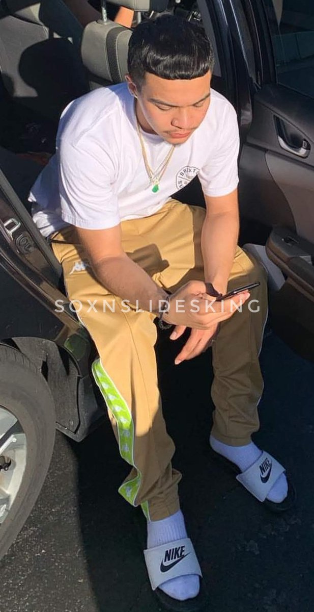 Soxnslidesking's tweet photo. Social media influencer Twansavage in a classic look. White Nike slides, white athletic socks. #soxnslidesking #socksandslides #hispanicmen #trending #sexy #nike https://t.co/kqpWM3Q8cr