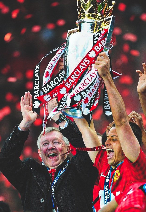 Javier Hernandez lifts the Premier League trophy and a jubilant Sir Alex Ferguson shows his joy of winning United's 20th league title, May 2013.