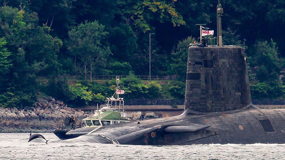 NavyLookout's tweet photo. Vanguard class submarine outbound from Faslane this evening with 🐬dolphin escort

Fine photo by @SheilaLWeir https://t.co/MGX3QQdcVy