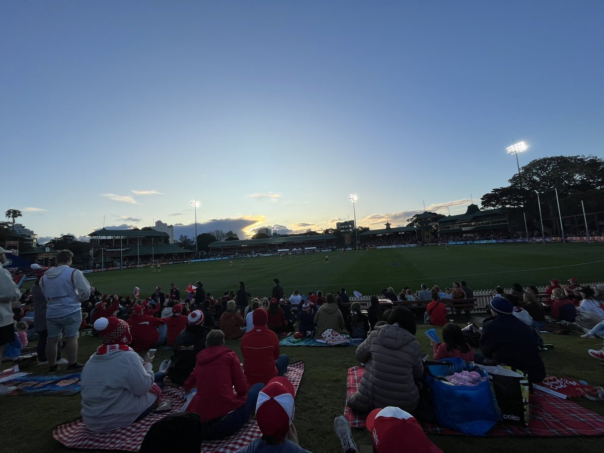 PrenterHayley's tweet photo. About to see the @SydneySwansAFLW girls debut! Pumping atmosphere at North Sydney Oval. So good to see the support for women in sport! History is being made tonight. @aflwomens #firsthappensonce #aflw #sydneyswans #bloods https://t.co/QeIgbvzfFD