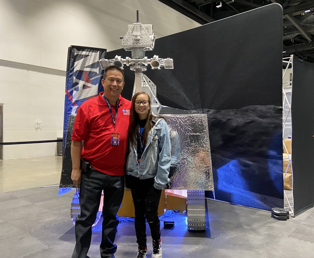 NASAAmes's tweet photo. Our @NASAAmes Center Director Eugene Tu and his daughter stopped by the @NASAExhibit at #SiliCon2022 to take a photo with our life-sized VIPER Moon rover model! #MoonRoverAndMe https://t.co/7j4CfJq87L
