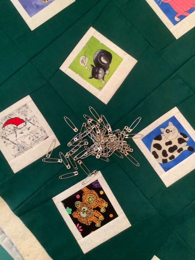 Pin basting the Polaroid cat quilt. Hope you are enjoying a creative day! #quilt #sewing #cats