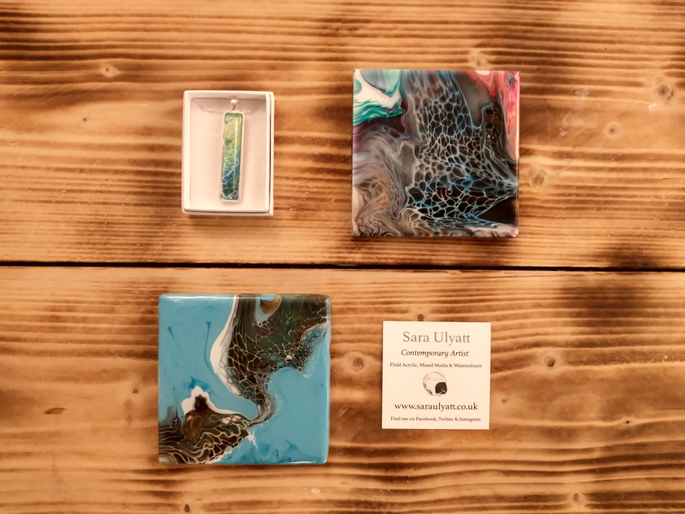 Here are just a few of the beautiful coasters &amp; necklaces by local artist <a href="/SaraUlyatt/">Sara Ulyatt</a>, in the float centre shop.
The photo doesn't do justice to the gorgeous shimmering iridescence she's captured... you'll just have to come and see them for yourself when you come for a float! 😍