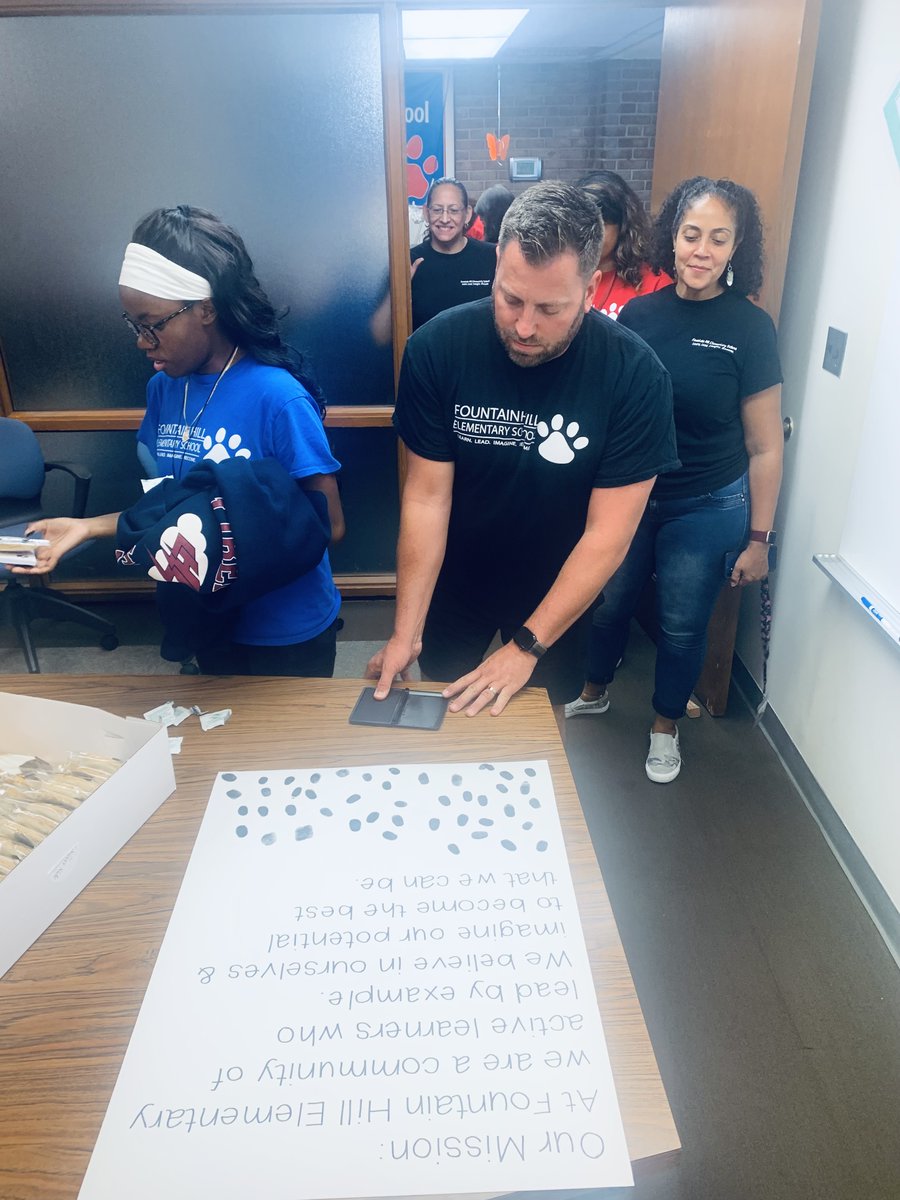 BASDFtHill's tweet photo. FHE's theme for this school year is "Leave your PAWprint." Staff left their print on our mission statement and posed for team pictures!🐾📸 #ItsAThrillOnTheHill #HillHappenings #BASDProud https://t.co/OcodXNL8Go