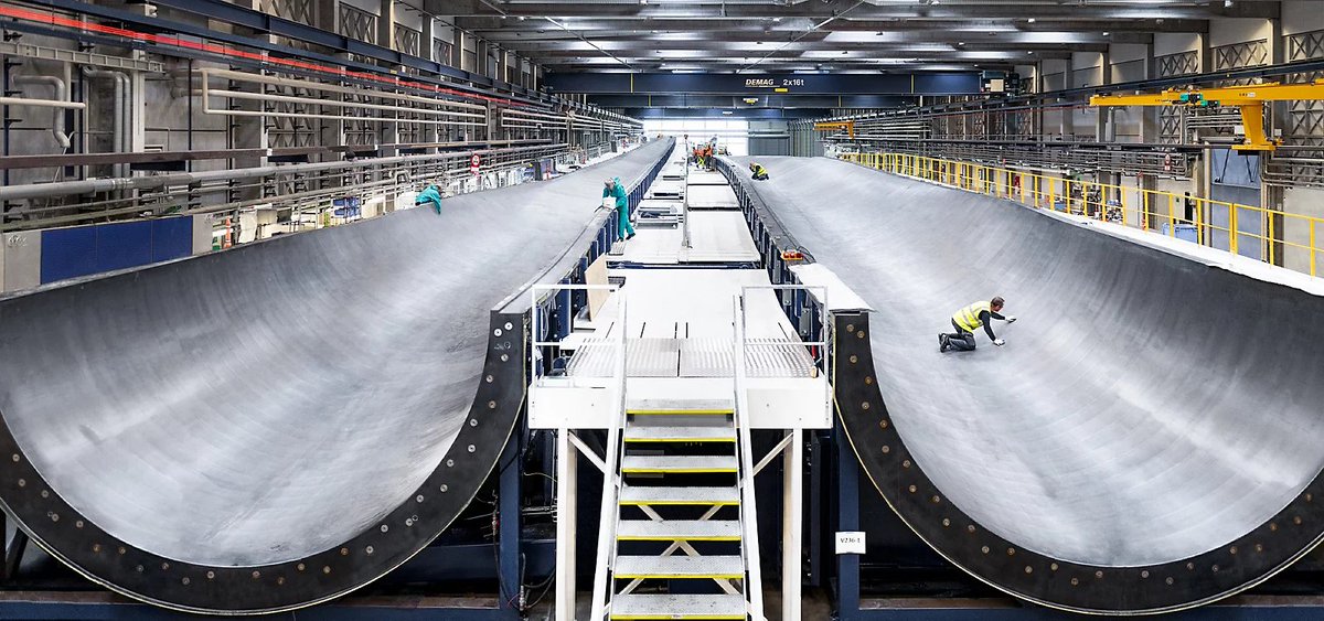 stshank's tweet image. Holy moly, wind turbines are getting enormous. You slot 115m blades into the 3 big holes at the front; they sweep an area of 43,742 square meters and produce up to 15 megawatts of power. @Vestas prototype installation starts this year. Photo shows blades. vestas.com/en/products/of…