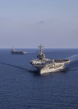 The Nimitz-class aircraft carrier USS George H.W. Bush (CVN 77), left, operates with the Nimitz-class aircraft carrier USS Harry S. Truman (CVN 75), Aug. 27, 2022. The George H.W. Bush Carrier Strike Group (GHWBCSG) is on a scheduled deployment in the U.S. Naval Forces Europe area of operations, employed by U.S. Sixth Fleet to defend U.S., allied and partner interests. (U.S. Navy photo by Mass Communication Specialist Seaman Samuel Wagner)