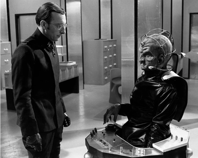 BraxM's tweet photo. Remembering Peter Miles, born this day in 1928, who played Nyder to Michael Wisher's Davros in the classic #DoctorWho story Genesis of the Daleks. Photographed by Don Smith at BBC TV Centre in February 1975 for @RadioTimes https://t.co/6BBUexqA1b https://t.co/SYvN1v9g4t