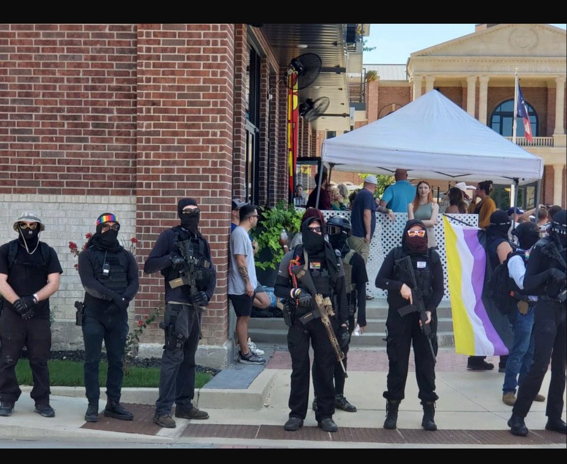alexbruesewitz's tweet photo. A bar in Roanoke, Texas that was allowing children to be exposed to hyper-sexualized drag queens had armed democrat activists stand outside to intimidate those protesting that sick &amp; demonic behavior.

Our country has gone to hell. https://t.co/rk9jWBlTSh