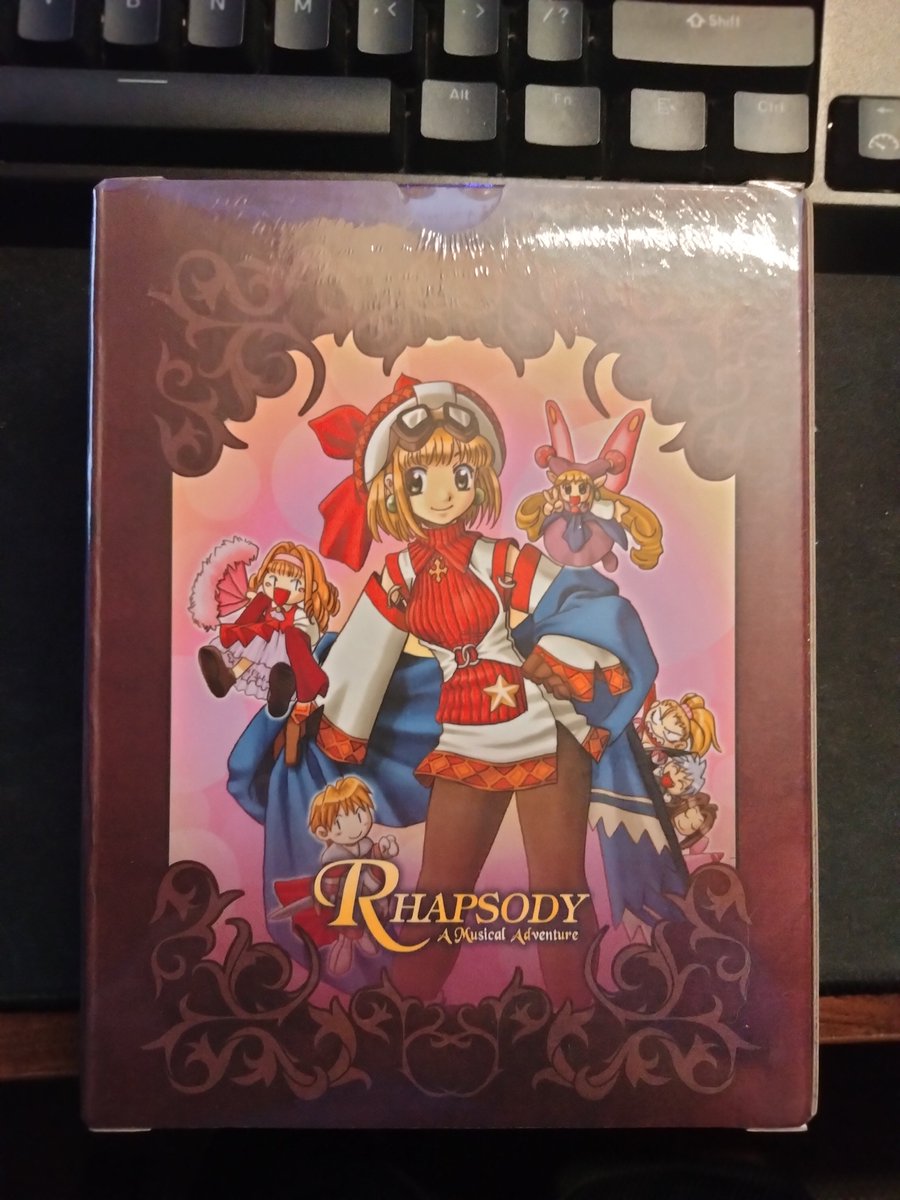 whom128's tweet photo. It's been 14 years since I could buy new Rhapsody merch.  I find it funny that they have a sticker that refers to the switch as the "Hybrid Device" https://t.co/qXLRP7E6NF