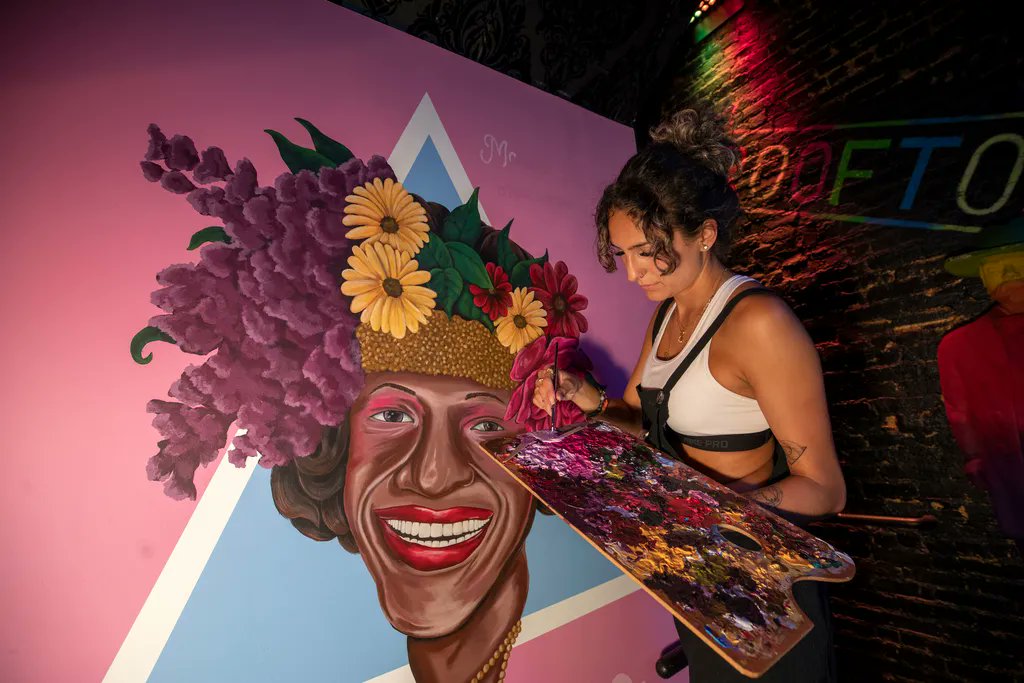 JerseyCity's tweet photo. Artist Stephanie Duque @SDuqueeee paints a mural of Gay liberation activist Marsha P. Johnson at the entrance of @six26_lounge at 128 Christopher Columbus Drive. Six26 commissioned the work to honor the trailblazer, who died in 1991. @hudsonpride @JerseyCityPride #MuralMonday https://t.co/xwOnv6Nsns