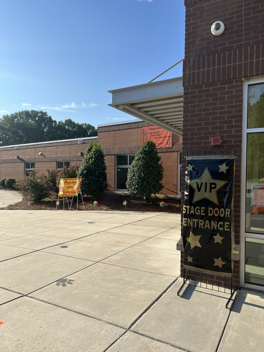 DiggsLatham's tweet photo. We are back! Students were excited to arrive to #TigerNation today, walking down a path of pinwheels spinning in the wind while banners reflected this year’s theme, #SettingtheStageforSuccess, & welcomed everyone to our @AplusSchoolsNC @MagnetSchlsMSA #WSFCSFirstDayPhotos https://t.co/a9EYsGwcNh
