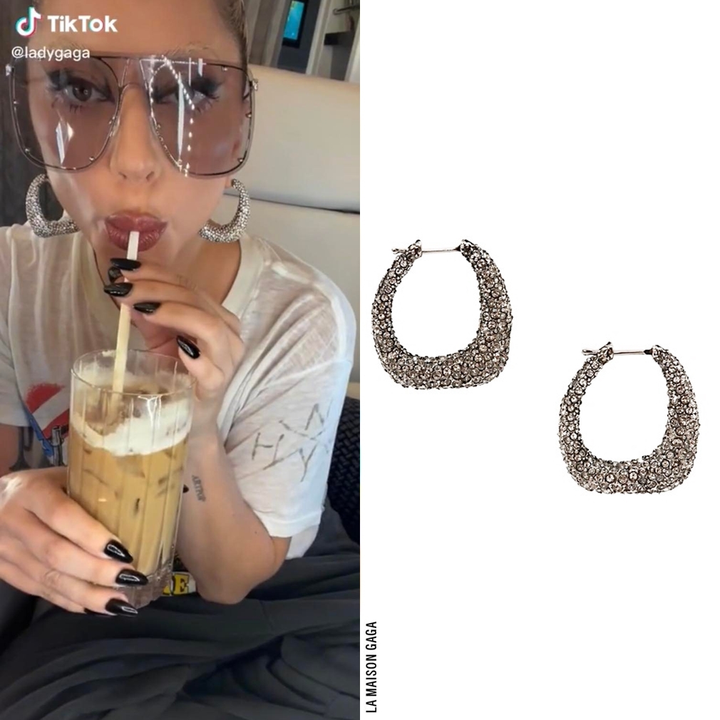 En route to Tokyo, Gaga wore her vintage @Anthrax 1987 'I Am The Law' tee, #JoahBrown's oversized French Terry joggers, and @McQueen Resort 2022 oversized shield sunnies and pavé crystal hoops.