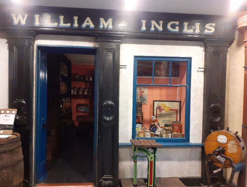 The first stop on our #JourneyThroughGladstoneCourt tour is William Inglis (1842-76), the Grocers. After William’s death in 1876, the shop was run by his wife, Annie and her brother-in-law John.