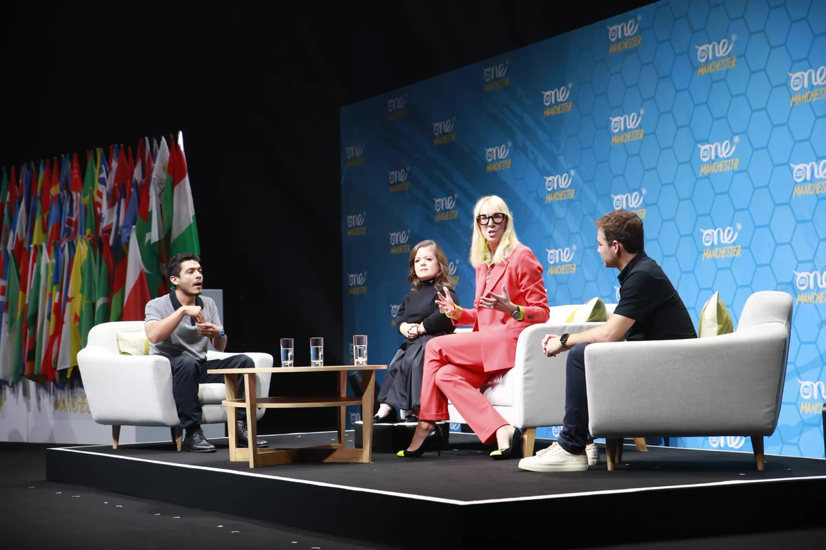 Sinéad Burke, Daniel Durant and his interpreter, and Caroline Casey sat on stage at One Young World Manchester