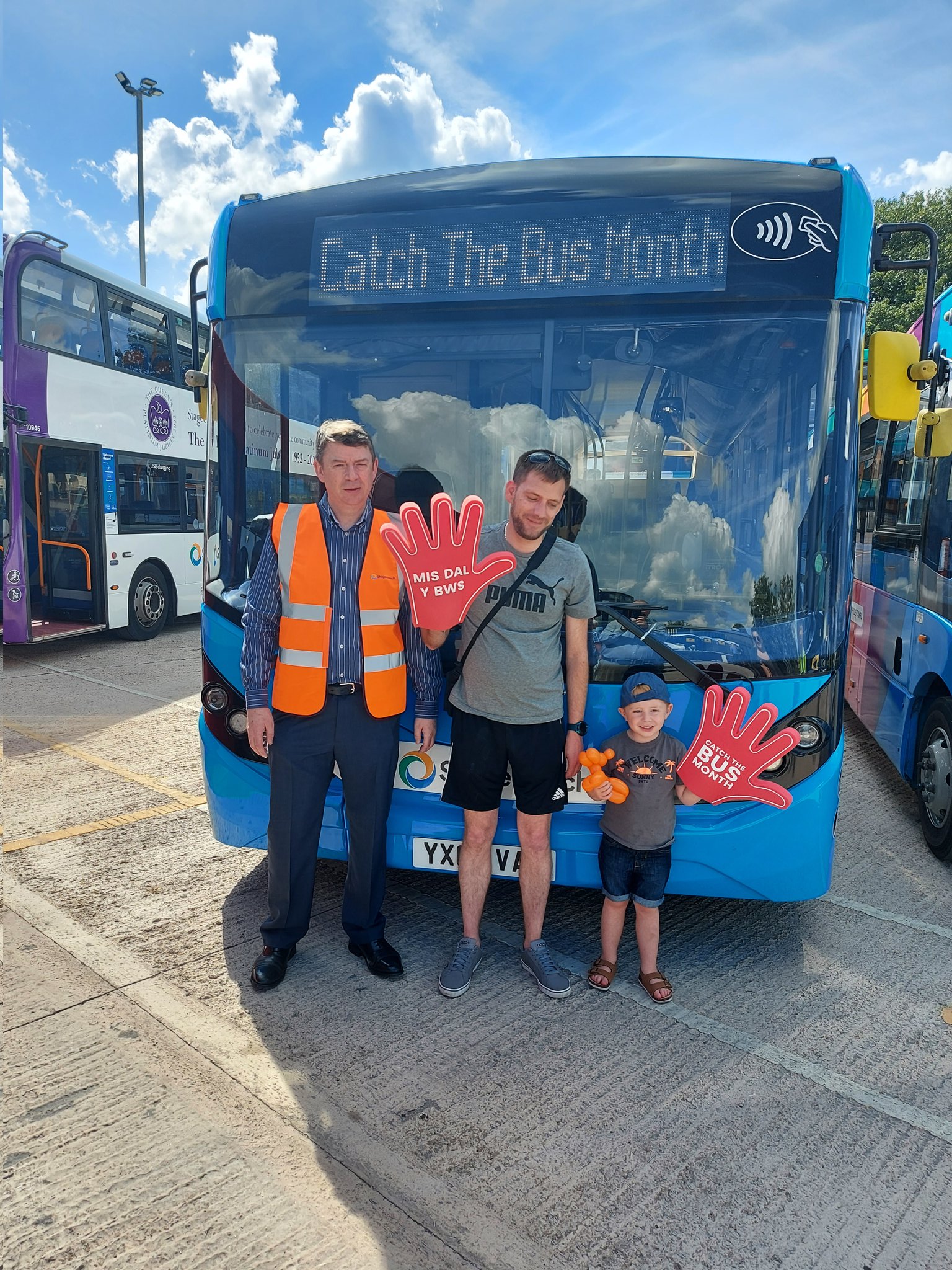 stagecoach south wales open day with father and son holding giant red hands