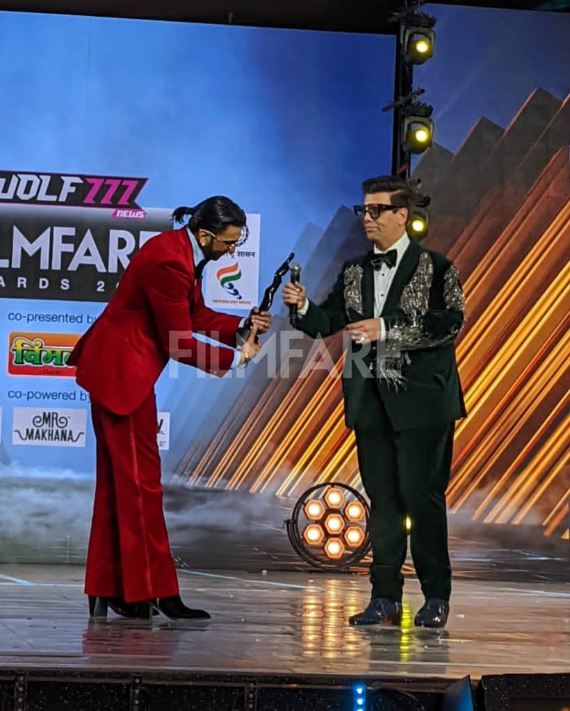filmfare's tweet photo. #RanveerSingh accepts the Best Actor in a Leading Role (Male) trophy from filmmaker #KaranJohar. The actor took home the award for his performance in 83 at the 67th #Wolf777newsFilmfareAwards 2022 with Government Of Maharashtra, Aazadi Ka Amrit Mahotsav.
#FilmfareAwards https://t.co/qo88hViKvN