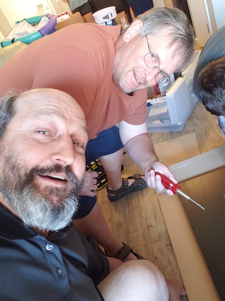 SlobodaVic's tweet photo. The two fathers working to make it look like we are working. It's a tough job letting your kids build Ikea. But fun to watch. 
#BuildThatShelf 
No work was actually performed in the making of this picture. https://t.co/xjlUPPtqBu
