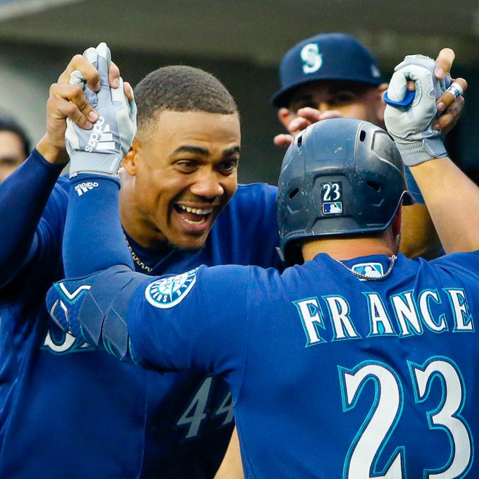 Julio Rodríguez and Ty France celebrate in the dugout. 