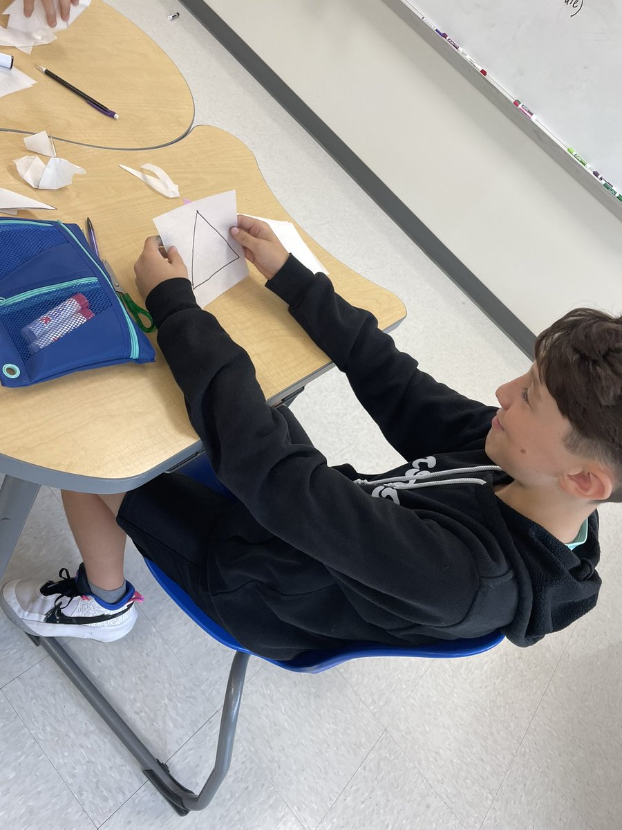 AmyPreston2021's tweet photo. 6th and 7th grade students trying to make various shapes using one cut! Mastered the triangle! #woim #youcubed #joboaler @ROSArockets https://t.co/TnlfAeFyuI