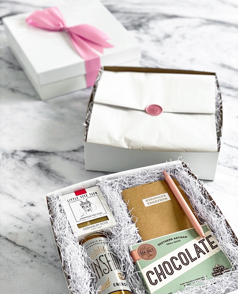 MementoAndMuse's tweet photo. Putting the final touches on some of our #StrongerTogether care packages. 💕 Who wouldn't be delighted to receive one of these special gifts? These pretty in pink beauties are filled with specialty soap from @littleseedfarm, a GingerBerry @drinkthesun… https://t.co/YI4pNIujoQ https://t.co/Ws8hZZ4N3t