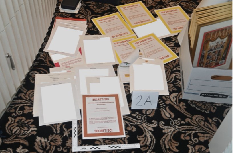 KellyO's tweet photo. NEW:  The Department of Justice filing submitted tonight includes a photo showing the obvious classification markings on documents seized at Mar-a-Lago. https://t.co/nVKAVXD9sT