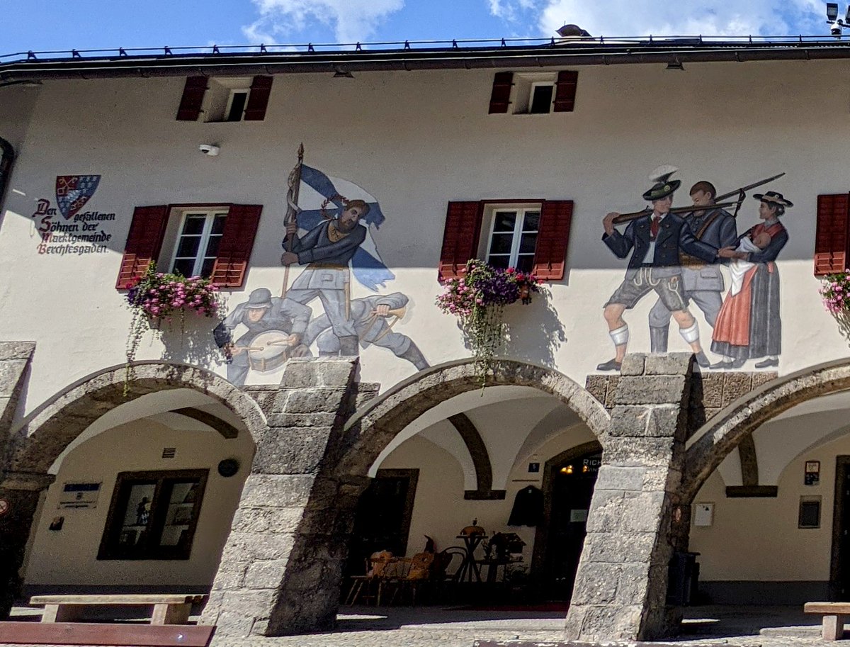 TommiesGuides's tweet photo. Stunning #FWW Berchtesgaden war memorial fresco above the arcade in the palace square. It depicts: Assault. Farewell to the Fatherland. God with us &amp; Homecoming. US forces painted over the original &amp; artist Josef Hengge replaced end scene (Trench Warfare) in 1952 &amp; added WW2 ref. https://t.co/fdZ16ObaTH