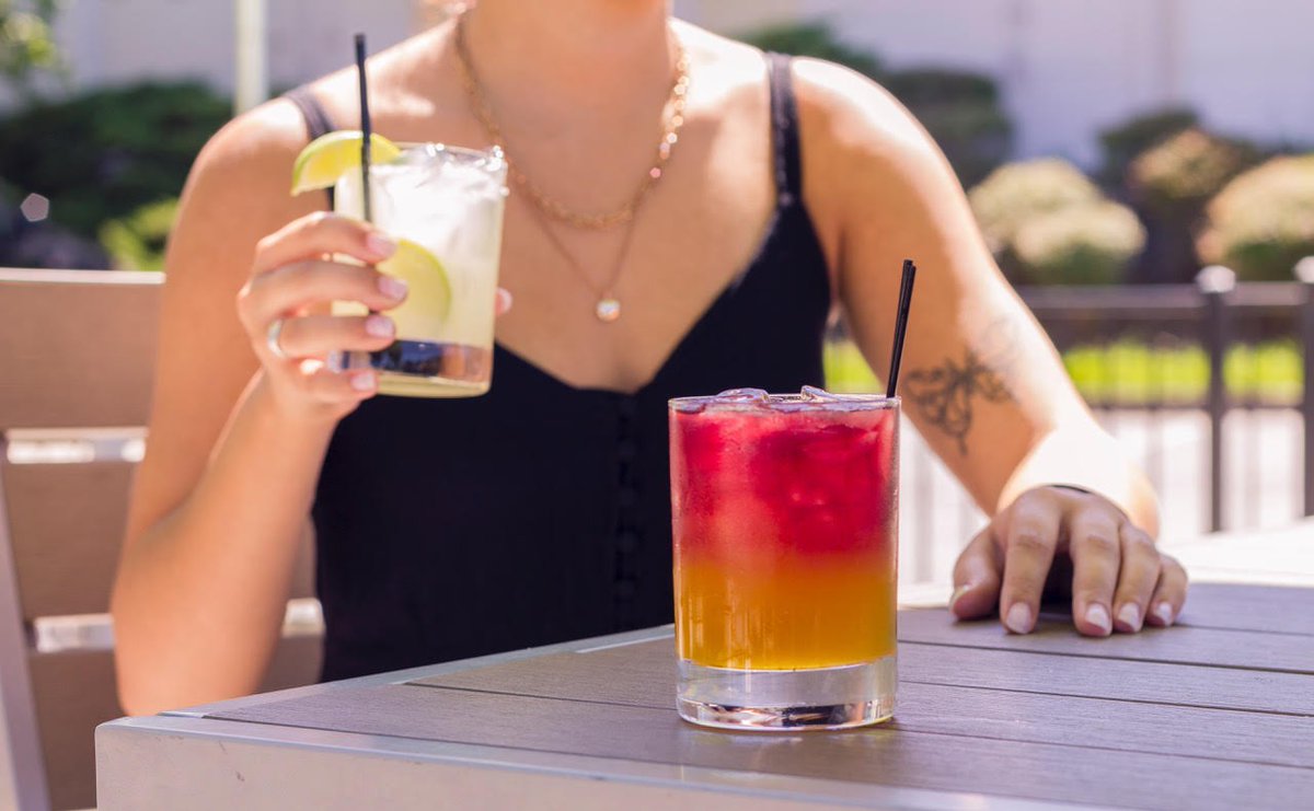 Rain or shine, today is #NationalEatOutsideDay - cheers to the great outdoors from our patio view! #MangoSangrita #Margarita #Drinks #patio #TaqueriaTsunami #letsdothis