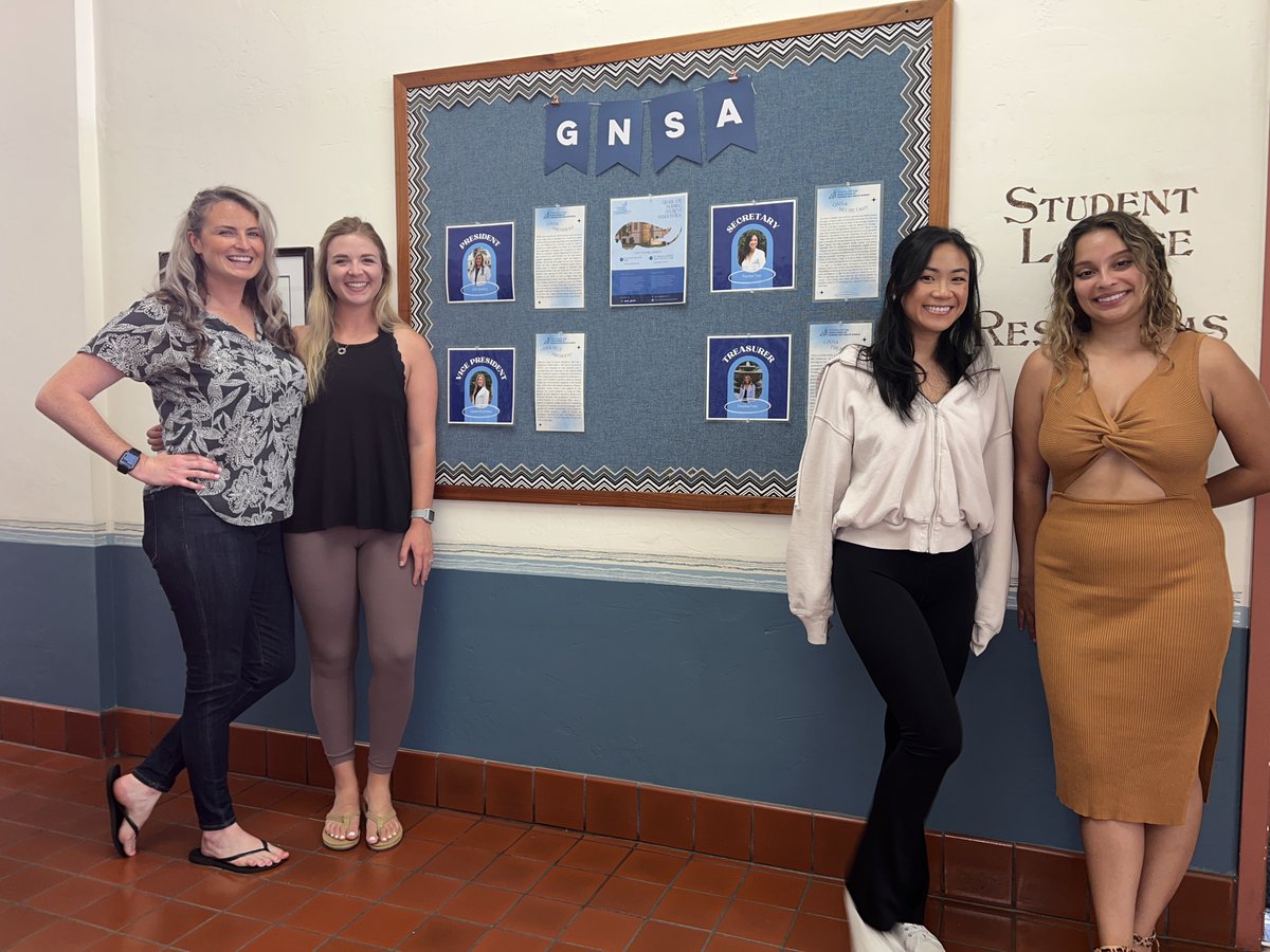 It's the first day of the fall semester and our GNSA board members are setting up their announcement board. They are Erin Keating, Lauren McGinness, Pauline Tran, and Emeline Polis.
