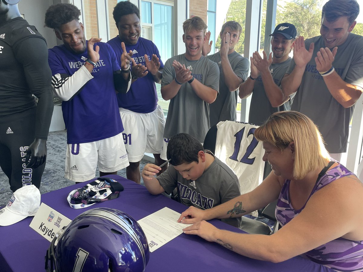 weberstate's tweet photo. New Wildcat! The @weberstatefb team signed 9-year old Kayden as part of @GoTeamIMPACT! 

#WeAreWeber https://t.co/iWnBbWkDPV